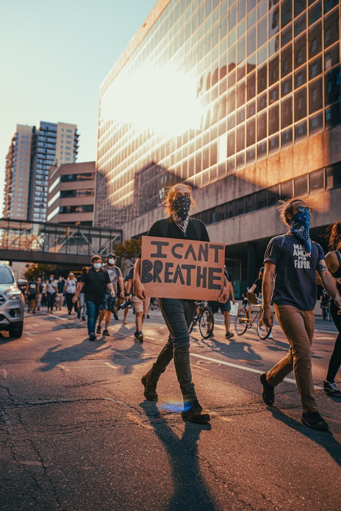 People protesting against racial injustice in Minneapolis, holding signs like I Cant Breathe.